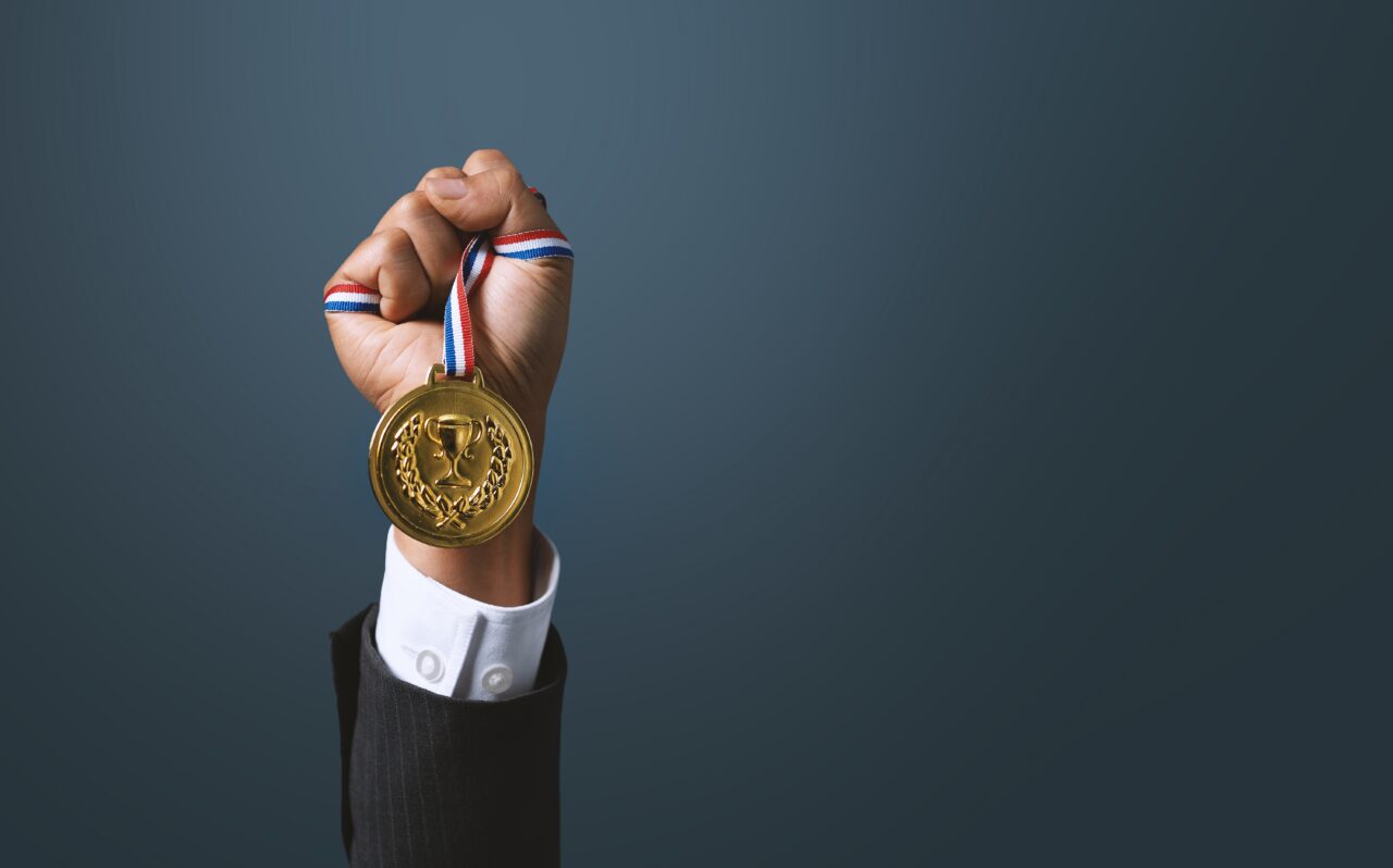 A,Business,Man,Holding,A,Gold,Medal.,Achieving,Success,In